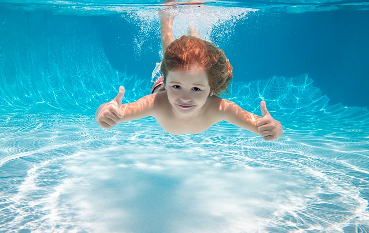 Child having fun in a nanobubble crystal clear swimming pool
